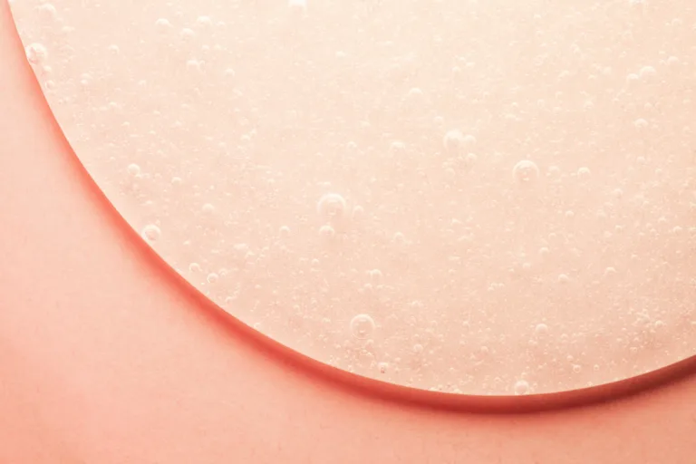 Organic cosmetic peach colored cream gel on craft background natural style